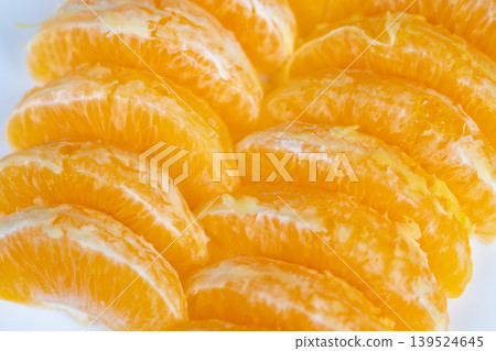 Photographic depiction of glossy orange segments with delicate membranes visible. Aesthetic arrangement of shiny orange slices showcasing fine membranes in warm inviting tones Photographic depiction of glossy orange segments with delicate membranes visible. Aesthetic arrangement of shiny orange slices showcasing fine membranes in warm inviting tones 139524645