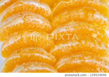 Colorful orange slices spread out. Closeup of lively orange slices on vibrant background. Playful arrangement of orange pieces with soft texture on colorful backdrop Colorful orange slices spread out. Closeup of lively orange slices on vibrant background. Playful arrangement of orange pieces with soft texture on colorful backdrop 139524646