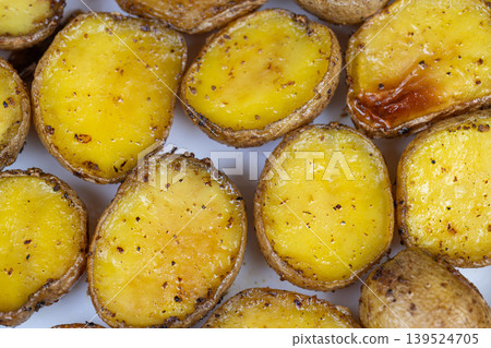 Delicious potato dish. Warm comfort food with crispy edges and tender centers. Perfect weeknight meal featuring golden roasted potatoes seasoned with butter and pepper Delicious potato dish. Warm comfort food with crispy edges and tender centers. Perfect weeknight meal featuring golden roasted potatoes seasoned with butter and pepper 139524705