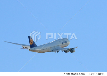 A passenger plane ascends: a 747 Jumbo Jet, operated by Lufthansa. 139524898