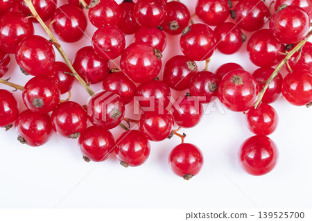 Fresh red currant bunches displayed. Natural red currants with rustic charm. Clusters of organic red currants capturing farm to table natural authenticity and rustic appeal Fresh red currant bunches displayed. Natural red currants with rustic charm. Clusters of organic red currants capturing farm to table natural authenticity and rustic appeal 139525700