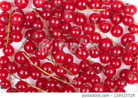 Closeup red currant berries for garnish, tart sheen on smooth skin, pastry chef ingredient suggestion, vibrant pop against neutral backdrop, primed for culinary styling Closeup red currant berries for garnish, tart sheen on smooth skin, pastry chef ingredient suggestion, vibrant pop against neutral backdrop, primed for culinary styling 139525729