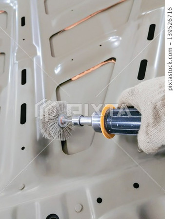 A scene of polishing and cleaning metal car parts using power tools. A scene of polishing and cleaning metal car parts using power tools. 139526716