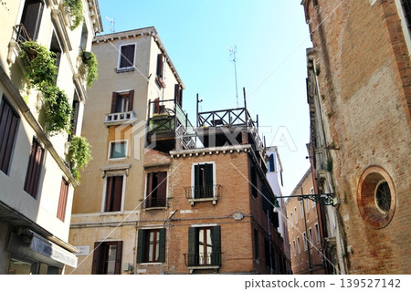 Altana (traditional rooftop terrace) of an apartment building in the San Marco district of Venice's old town, Italy. Altana (traditional rooftop terrace) of an apartment building in the San Marco district of Venice's old town, Italy. 139527142