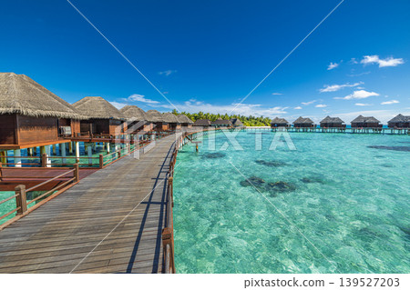 Stunning Maldives water villas over turquoise lagoon, overwater bungalows on tropical pier extending into calm ocean, luxury travel destination, idyllic paradise resort, serene tropical escape, scenic Stunning Maldives water villas over turquoise lagoon, overwater bungalows on tropical pier extending into calm ocean, luxury travel destination, idyllic paradise resort, serene tropical escape, scenic 139527203