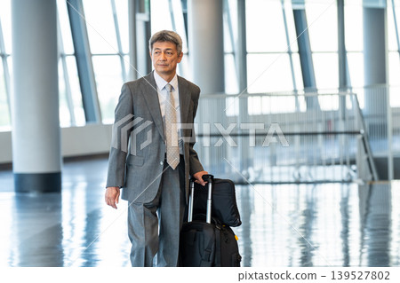 Businessman walking with a carry bag Businessman walking with a carry bag 139527802