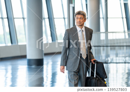 Businessman walking with a carry bag Businessman walking with a carry bag 139527803