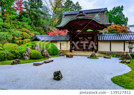 The Shigaraki garden, with its beautiful autumn foliage and white sand, is a stunning dry landscape garden as viewed from the Shakado Hall of Komyoji Temple in Kyoto. The Shigaraki garden, with its beautiful autumn foliage and white sand, is a stunning dry landscape garden as viewed from the Shakado Hall of Komyoji Temple in Kyoto. 139527852