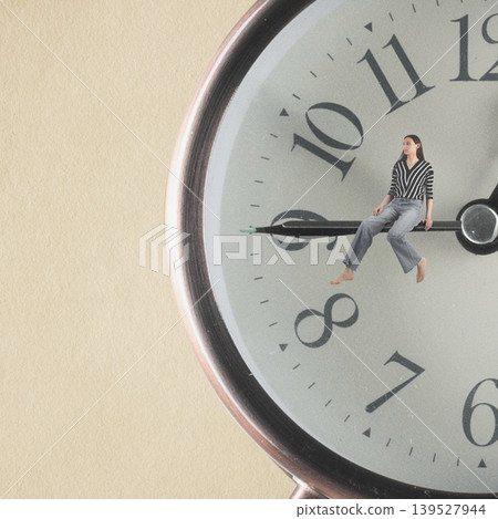 Woman experiencing time management and waiting on clock hand Woman experiencing time management and waiting on clock hand 139527944