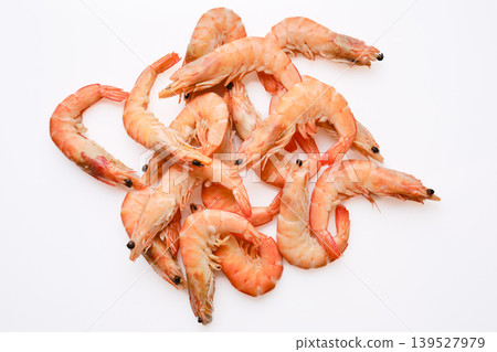 Fresh shrimp arranged on a white surface ready for cooking or serving in a meal Fresh shrimp arranged on a white surface ready for cooking or serving in a meal 139527979