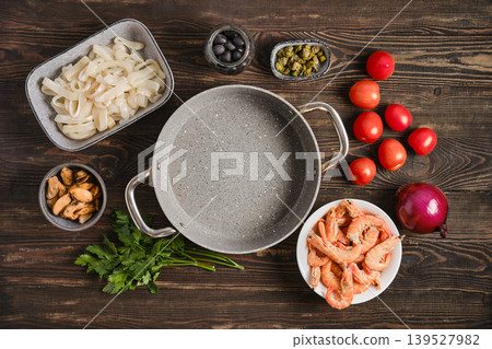 Ingredients for seafood dish with cooking pot on wooden surface in kitchen Ingredients for seafood dish with cooking pot on wooden surface in kitchen 139527982