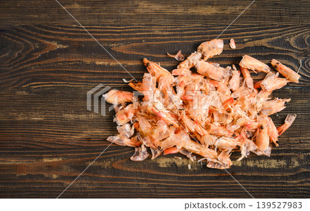 Shrimp shells are placed on a wooden table after shrimp preparation Shrimp shells are placed on a wooden table after shrimp preparation 139527983