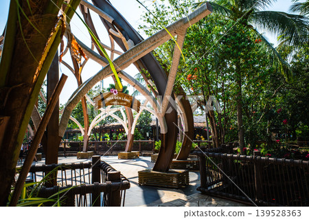 The entrance arch to a lantern house in a tropical theme park. A decorative element of a tourist attraction. The entrance arch to a lantern house in a tropical theme park. A decorative element of a tourist attraction. 139528363
