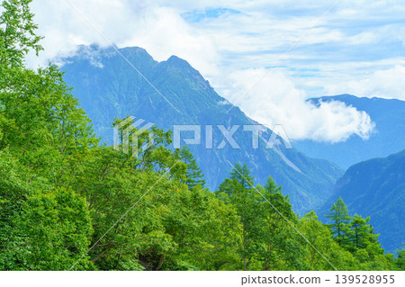 The rocky peaks of the Northern Alps and the mountain landscape shrouded in mist, as seen from the Mt. Yake climbing trail. The rocky peaks of the Northern Alps and the mountain landscape shrouded in mist, as seen from the Mt. Yake climbing trail. 139528955