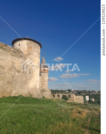 Ancient stone fortress wall under blue sky, historic architecture detail Ancient stone fortress wall under blue sky, historic architecture detail 139529023
