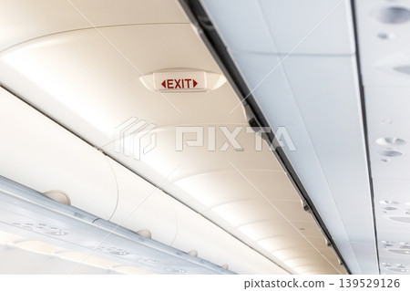 Emergency exit sign inside airplane cabin Emergency exit sign inside airplane cabin 139529126