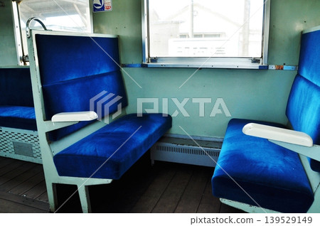 The blue box seats and wooden floor of the retro-style diesel railcar Kiha 205 from the Showa era. The blue box seats and wooden floor of the retro-style diesel railcar Kiha 205 from the Showa era. 139529149