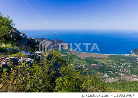 Panoramic Coastal View From Rocky Cliff Overlooking Blue Sea, Bay and Lush Valley Panoramic Coastal View From Rocky Cliff Overlooking Blue Sea, Bay and Lush Valley 139529464