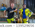 Black Male 20-30s and White Male 30-40s Engineers Posing with Industrial Robotic Arm 139529656