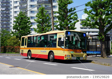 A Kanagawa Chuo Bus (old livery/Mitsubishi Aero Star) stopped at a bus stop in front of an apartment complex. A Kanagawa Chuo Bus (old livery/Mitsubishi Aero Star) stopped at a bus stop in front of an apartment complex. 139529820