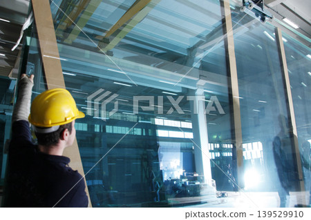 Glass manufacturing factory. Workers in the factory. Glass manufacturing factory. Workers in the factory. 139529910