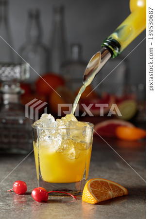 Orange juice poured into a glass with ice. Orange juice poured into a glass with ice. 139530687