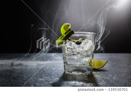 Vodka with lime and ice cubes in a fogged up glass. Vodka with lime and ice cubes in a fogged up glass. 139530701
