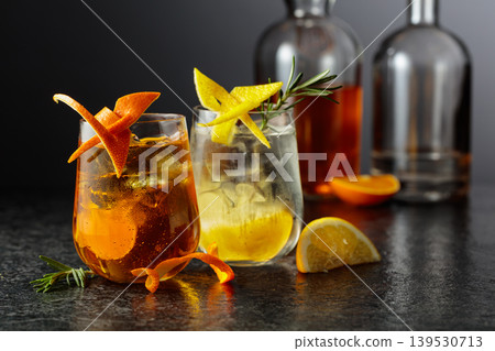 Cocktails with whiskey and gin in a fogged up glasses on a black table in bar. 139530713