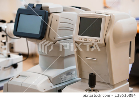 Close-up of ophthalmic diagnostic equipment in optical clinic featuring medical technology and precision instruments for eye care Close-up of ophthalmic diagnostic equipment in optical clinic featuring medical technology and precision instruments for eye care 139530894
