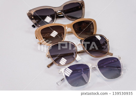 Four fashion sunglasses lined up on white background with different frames and lenses for retail display or accessory collection concept Four fashion sunglasses lined up on white background with different frames and lenses for retail display or accessory collection concept 139530935