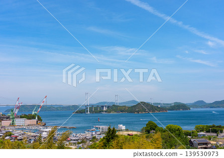 A spectacular view of the Kurushima Kaikyo Bridge and the Seto Inland Sea from the observation terrace of the Kurushima Kaikyo Service Area, Imabari City, Ehime Prefecture. 139530973
