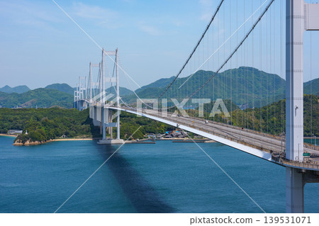 A spectacular view of the Kurushima Kaikyo Bridge and the Seto Inland Sea from Itoyama Park, the world's first triple suspension bridge, in Imabari City, Ehime Prefecture. A spectacular view of the Kurushima Kaikyo Bridge and the Seto Inland Sea from Itoyama Park, the world's first triple suspension bridge, in Imabari City, Ehime Prefecture. 139531071