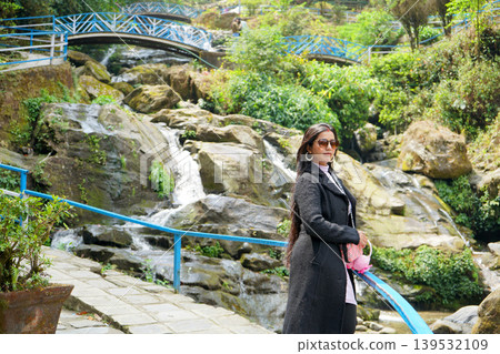 Beautiful young woman enjoying the scenic beauty of the Rock Garden waterfall in Darjeeling 139532109