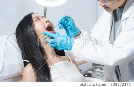 Dentist examining oral health, dental checkup and treatment. Dentist examining oral health, dental checkup and treatment. 139532275