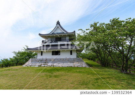 A castle-like building and the scenery of fresh greenery at Kaiyama Castle Ruins Observation Park in Imabari City, Ehime Prefecture. 139532364