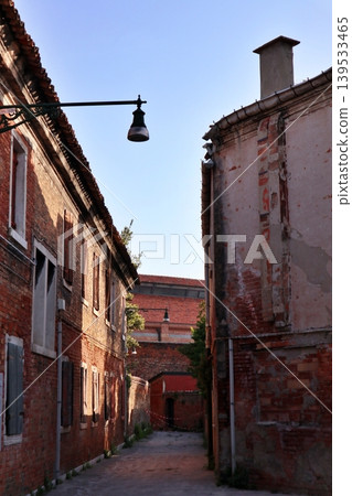 Murano, off the coast of Venice, Italy: An alley in the old town of San Stefano Island. Murano, off the coast of Venice, Italy: An alley in the old town of San Stefano Island. 139533465
