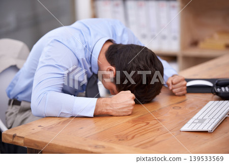 Business man, stress and resting on desk, burnout and mental health or overworked in workplace. Male professional, frustration and banging table in anger, bankrupt and overwhelming debt or pressure Business man, stress and resting on desk, burnout and mental health or overworked in workplace. Male professional, frustration and banging table in anger, bankrupt and overwhelming debt or pressure 139533569