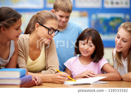 Happy teacher, students and writing for education, learning or tutoring in classroom at school. Woman, mentor or educator helping young kids or children with books for studying or literature in class Happy teacher, students and writing for education, learning or tutoring in classroom at school. Woman, mentor or educator helping young kids or children with books for studying or literature in class 139533582