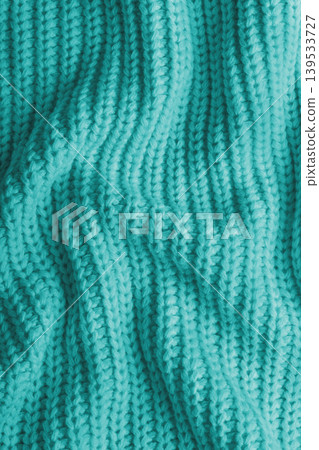 Turquoise knitted fabric texture with folds, wrinkles and soft waves, crumpled wool background Turquoise knitted fabric texture with folds, wrinkles and soft waves, crumpled wool background 139533727
