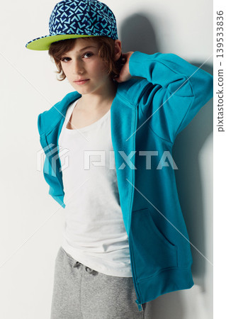 Portrait, fashion and confident child in a hoodie in studio isolated on a white background. Trendy style, cool kid and cap of young boy in a hat, casual clothes and serious on a backdrop in Sweden Portrait, fashion and confident child in a hoodie in studio isolated on a white background. Trendy style, cool kid and cap of young boy in a hat, casual clothes and serious on a backdrop in Sweden 139533836