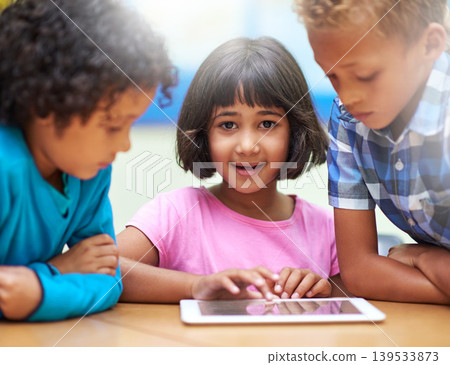 Girl, students learning and tablet in classroom for online education, teaching and information in portrait. Young kids with digital technology for school knowledge, internet and development software Girl, students learning and tablet in classroom for online education, teaching and information in portrait. Young kids with digital technology for school knowledge, internet and development software 139533873