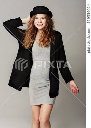 Happy, woman and portrait with vintage fashion, style and aesthetic in grey background of studio. Confident, smile and girl with pride in unique or retro clothing with model in hat for trendy outfit Happy, woman and portrait with vintage fashion, style and aesthetic in grey background of studio. Confident, smile and girl with pride in unique or retro clothing with model in hat for trendy outfit 139534024