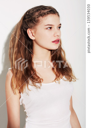 Fashion, makeup and young woman in a studio with beauty, cosmetic and glamour face routine. Confident, natural and beautiful female model with hairstyle for style isolated by white background. Fashion, makeup and young woman in a studio with beauty, cosmetic and glamour face routine. Confident, natural and beautiful female model with hairstyle for style isolated by white background. 139534030