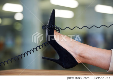 Telephone, wire and woman with shoe on desk to relax on phone call in office with confidence or pride. Technology, cord and cable on high heel or foot of person with communication or landline contact 139534053