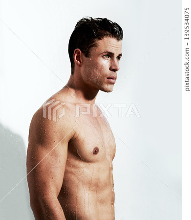 Shower, sexy and body of man with water for washing, cleaning and skincare wellness. Young, hot and muscular male model person with grooming and hygiene for healthy skin by white studio background. Shower, sexy and body of man with water for washing, cleaning and skincare wellness. Young, hot and muscular male model person with grooming and hygiene for healthy skin by white studio background. 139534075