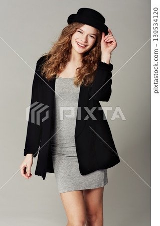 Vintage, fashion and happy portrait of woman with style or aesthetic in grey background of studio. Confident, smile and girl with pride in unique or retro clothing with model in hat for trendy outfit Vintage, fashion and happy portrait of woman with style or aesthetic in grey background of studio. Confident, smile and girl with pride in unique or retro clothing with model in hat for trendy outfit 139534120