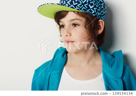 Thinking, fashion and young child in a hoodie in studio isolated on a white background. Trendy style, cool kid and cap of boy or model in a hat, casual clothes and serious on a backdrop in Sweden Thinking, fashion and young child in a hoodie in studio isolated on a white background. Trendy style, cool kid and cap of boy or model in a hat, casual clothes and serious on a backdrop in Sweden 139534134