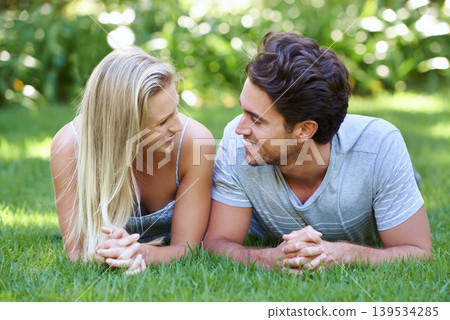Relax, love or happy couple on grass in park for date, support or care on a summer in nature together. Romance, man or woman with smile on outdoor holiday vacation for bond, travel or freedom in USA Relax, love or happy couple on grass in park for date, support or care on a summer in nature together. Romance, man or woman with smile on outdoor holiday vacation for bond, travel or freedom in USA 139534285