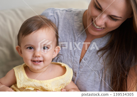 Mother, baby and portrait smile in relax of adorable and happy little girl sitting on mommy at home. Face of mama holding young newborn child, kid or toddler for parenting, bonding or love at house Mother, baby and portrait smile in relax of adorable and happy little girl sitting on mommy at home. Face of mama holding young newborn child, kid or toddler for parenting, bonding or love at house 139534305