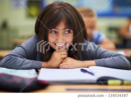 Girl, education and happy in classroom for learning, information and notes for knowledge in school. Female person, book and confidence for assessment or test, studying lesson and smiling at academy Girl, education and happy in classroom for learning, information and notes for knowledge in school. Female person, book and confidence for assessment or test, studying lesson and smiling at academy 139534397